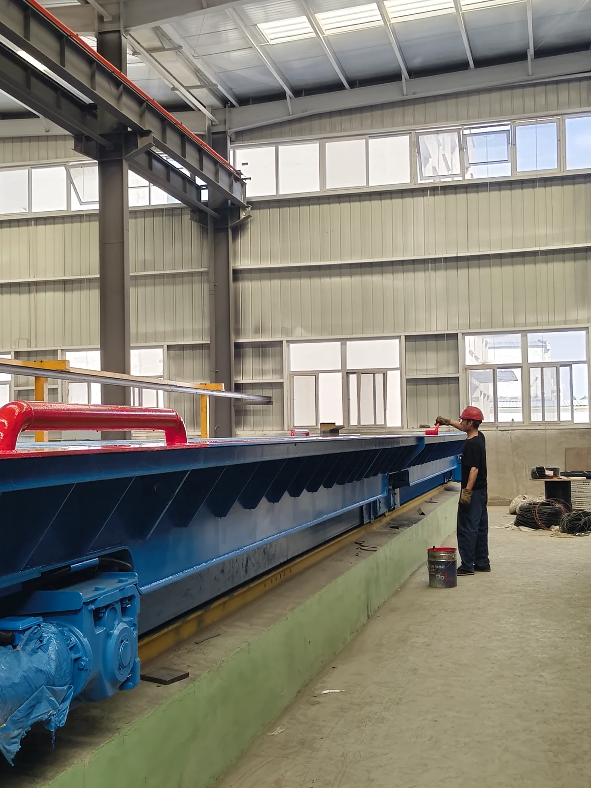 A worker finishing a blue motor-driven loading platform