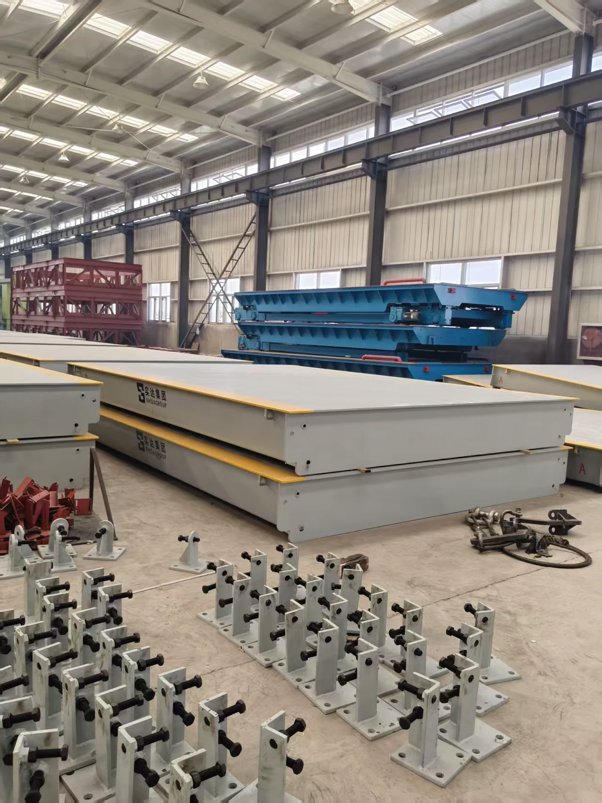 Mounting components and completed weighbridge decks in the workshop